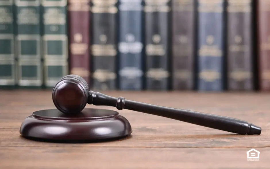 Gavel on table in front of books