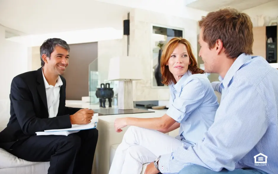 Man having discussion with couple in living room