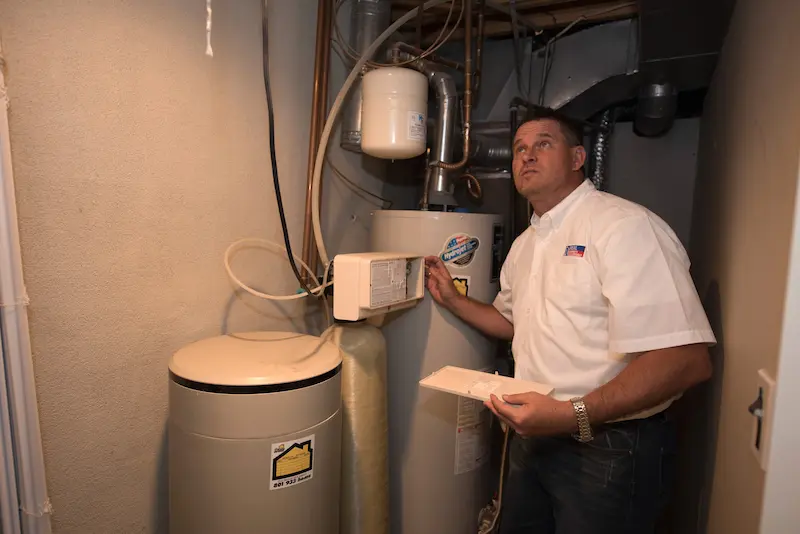 A man inspecting a water heater