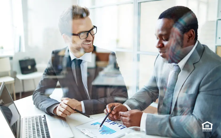 Two men discussing business charts