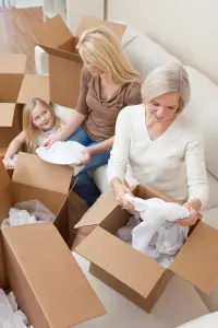 Three women unpacking boxes