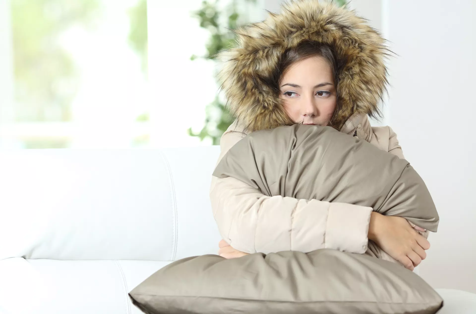 woman bundled up in a cold house