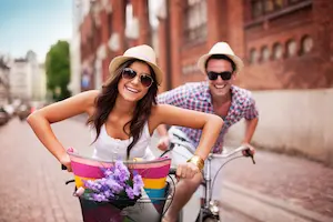 A young couple riding bicycles